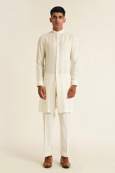 Ivory silk open bandhgala with overlap lapel panel and tonal French knot thread embroidery. Paired with plain full sleeves kurta and straight fit pyjama.
Components: 3
Pattern: Embroidered
Type Of Work: French Knot Thread Work
Neckline: Bandhgala: Lapel Collar, Kurta: Band Collar
Sleeve Type: Full Sleeves
Fabric: Silk
Color: Ivory
Other Details: 
Side slits
Kurta Closure: Front button placket
Occasion: Cocktail and Reception,Destination Wedding - Aza Fashions Elegant White Kurta With Cutdana, Fitted Off White Kurta With Naqshi, Elegant Formal Nehru Jacket With Cutdana, Formal Off White Kurta With Cutdana, Formal Off-white Kurta With Cutdana, Elegant Nehru Jacket With Cutdana In Traditional Drape, Elegant Bandhgala With Cutdana For Ceremonial Occasions, Elegant Nehru Jacket With Cutdana Detailing, Elegant Nehru Jacket With Cutdana