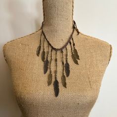 Braided Leather Bib Necklace with Pewter Feathers by Amy Kaplan. Amy is a truly talented artisan who has been hand crafting high quality custom jewelry for cowgirls with discriminating taste. You'll have a unique custom piece of western jewelry that stands out from the crowd. Braided leather cord necklace, pewter feather and arrow charms with horn and brass beads. Feather bib necklace. Vintage Necklaces With Adjustable Length For Festivals, Festival Metal Necklace With Adjustable Cord, Adjustable Metal Necklaces For Festivals, Adjustable Cord Metal Necklace For Festivals, Vintage Brown Jewelry With Adjustable Chain, Brown Hippie Jewelry For Festivals, Adjustable Leather Vintage Necklace, Vintage Adjustable Leather Necklace, Hippie Brown Jewelry For Festivals