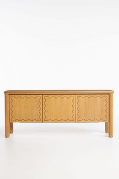 a wooden sideboard with three drawers on one end and two doors on the other