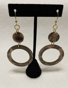 These are beautiful brown statement earrings. They are neutral but not boring and come with gold nickel free fishhook backings that are hypoallergenic. The resin is colored with two shades of brown so they have a marbled effect in the sunlight making them great for day and night wear. They are lightweight as they are made with resin and colored with mica pigment so they have a slight shimmer as well. Brown Brass Drop Earrings, Earthy Brown Copper Earrings, Nickel-free Brown Brass Earrings, Earthy Brown Earrings With Ear Wire, Everyday Hypoallergenic Brown Jewelry, Brown Metal Dangle Earrings, Brown Dangle Metal Earrings, Hypoallergenic Brown Round Earrings, Earthy Brown Drop Earrings