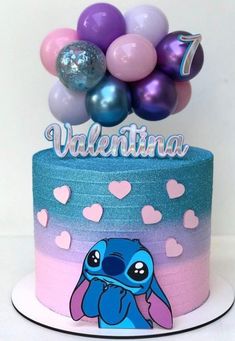 a birthday cake decorated with balloons and an image of stitcher from the movie lilpui