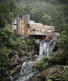 a house on top of a waterfall surrounded by trees