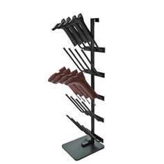 a black metal rack with five pairs of shoes on it and one pair of pants hanging from the top