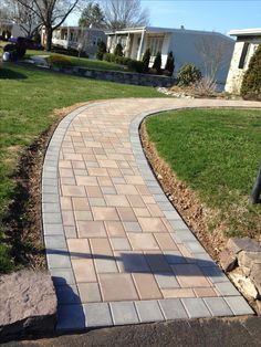 a brick walkway in front of some houses