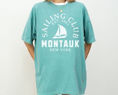 Sail into style with our Montauk Sailing Club Comfort Colors Short Sleeve T-Shirt. This tee embodies vintage retro sailing vibes, perfect for sailing enthusiasts and lovers of classic nautical fashion. Crafted from soft, durable Comfort Colors cotton, it offers a relaxed fit and timeless appeal. Embrace the spirit of Montauk's sailing heritage with this stylish and comfortable t-shirt. Size up 1-2 sizes for oversized fit! Comfort Colors® Unisex T-Shirt * * * * * * * * * * * * * * * * * * * * * * Montauk New York, Hamptons New York, New York Shirt, Nautical Fashion, Yacht Club, Color Shorts, Comfort Colors, The Hamptons, San Jose