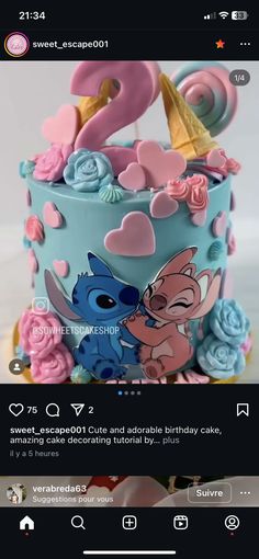 the cake is decorated with pink and blue icing, flowers and hearts on it