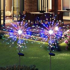 colorful fireworks are lit up in the yard at night with flowers and patio furniture nearby