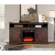 an entertainment center with a fire place in the middle and a painting on the wall