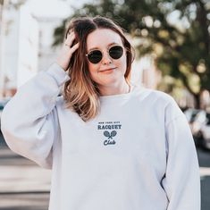 "*SIZES ARE UNISEX* -For women, I'd suggest your usual size for a regular fit (size up for a more relaxed fit). Men should size up for a more relaxed fit. *these sweatshirts are extra comfy when oversized 🏸 \"New York City Racquet Club\" embroidered in navy on a comfy vintage-style crewneck. This cute crewneck is inspired by brandy melville and vintage nike sweatshirts. Perfect for any occasion or gift for him or her. A sturdy and warm sweatshirt bound to keep you warm in the colder months. A p Cotton Tennis Sweatshirt With Relaxed Fit, Cotton Tennis Sweatshirt In Relaxed Fit, Cotton Crew Neck Sweatshirt For Tennis, Cotton Crew Neck Tennis Sweatshirt, Casual Relaxed Fit Sweatshirt For Tennis, Long Sleeve Relaxed Fit Sweatshirt For Tennis, Tennessee Sweatshirt, Racquet Club, Cute Crewneck