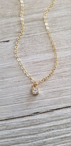 Dainty necklace features a tiny cz pendant that hangs from 14k gold filled and closes with a clasp. Looks great by itself or layered with your favorite necklace. Pendant measures 4mm x 6.6mm Select desired length from drop box. All your items will be packaged and shipped in a cotton filled kraft box. ~The best way to prevent tarnish is to wear your jewelry regularly. When not wearing your jewelry, the best way to protect it is to store it in a sealed plastic bag. Humidity, chemicals and chlorine Gold Solitaire Pendant Necklace For Everyday, Everyday Gold Solitaire Pendant Necklace, Everyday Delicate Cubic Zirconia Charm Necklaces, Gold Solitaire Necklace With Delicate Chain For Everyday, Dainty Gold Solitaire Necklace, Simple Gold Solitaire Necklace With Delicate Chain, Minimalist Gold Solitaire Necklace With Cubic Zirconia, Simple Solitaire Necklace With Delicate Gold Chain, Dainty Gold Solitaire Necklace With Adjustable Chain