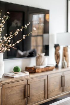 How To Style A TV Console: Decor And Functionality Asymmetrical Tv Console, Media Center Styling, Decor Under Mounted Tv Living Rooms, Tv Console Table Ideas, Styling A Tv Stand Living Rooms, Tv Above Sideboard Ideas, Frame Tv Over Buffet, Bedroom Console Table Under Tv