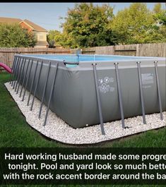 an above ground pool surrounded by rocks and gravel with the words hard working husband made some progress tonight, pool and yard look so much better