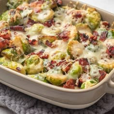 a casserole dish with brussel sprouts, bacon and cheese