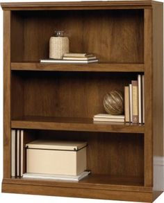 a wooden book shelf with books and other items on it