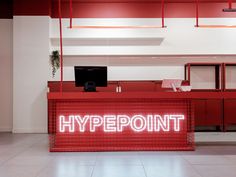 a red reception desk with the word hyppoint lit up