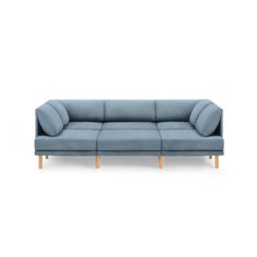 a blue couch sitting on top of a white floor