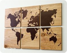 three black and white paintings on a wall with the map of the world painted on it