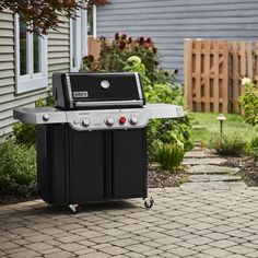 a bbq grill sitting on top of a brick patio