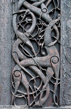 an intricate carving on the side of a building with scissors and other things in it