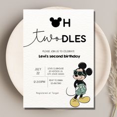 a mickey mouse birthday party card on a plate