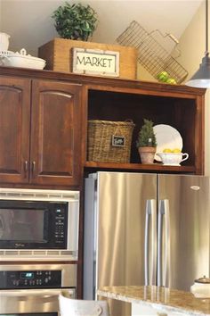 a kitchen with wooden cabinets and stainless steel appliances