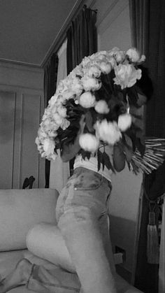 a black and white photo of someone's legs with flowers on them