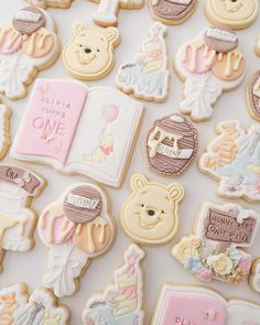 baby shower cookies are arranged in rows on a white surface with pink and blue accents