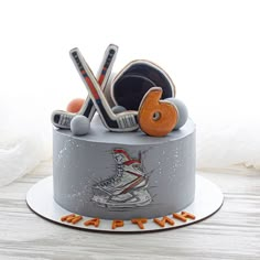 a hockey themed cake with sports equipment on top