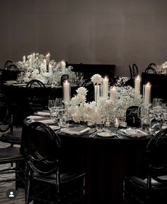 a dining room table is set with candles and centerpieces for an elegant dinner