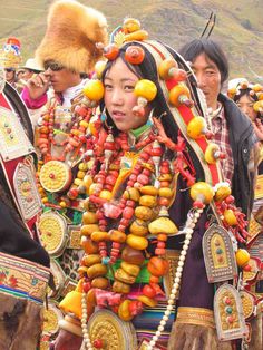 a group of people dressed in costume and headdress