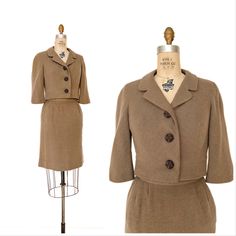 "The chicest vintage suit from the one and only Adele Simpson!  Late 1950s/early 1960s skirt suit in soft, light weight wool or wool blend crepe in the perfect shade of cool sandy brown. Short, almost cropped jacket with ¾ length sleeves cut in one with bodice and wide hemline. V neck with notched collar and large plastic buttons that looks almost beaded. Original matching pencil skirt with shallow pocket at each hip. Side zipper. Bothpieces ar lined in matching silk. Labeled Adele Simpson. Very good condition, no flaws to note. Jacket 16\" long 36\" bust 29\" waist 21\" neckline to end of sleeve Skirt 21\" long 1.5\" hem to let out 25\" waist 36\" hips" Fitted Vintage Blazer For Career, 60s Suit Women, Fitted Vintage Career Blazer, Vintage Fitted Blazer For Career, Vintage Wool Suits, Tailored Vintage Career Outerwear, Fitted Vintage Beige Suit, Classic Fitted Wool Skirt Suit, Vintage Tailored Career Outerwear