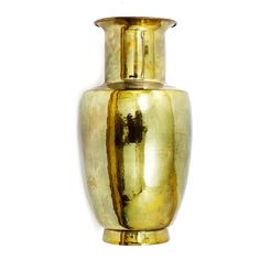 a gold colored vase sitting on top of a white wall