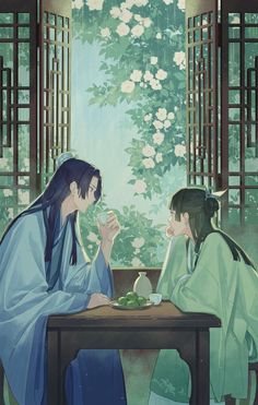 two women sitting at a table drinking tea