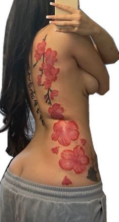 a woman is taking a selfie with her cell phone and flowers on her back