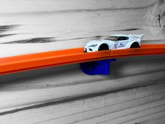 a toy car sitting on top of an orange shelf