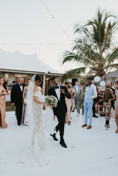 a bride and groom walking down the aisle after their wedding ceremony at an outdoor venue