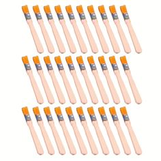 twelve orange toothbrushes are lined up in a row