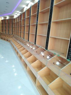 the shelves are lined up in rows with lights on each shelf and below them is an empty swimming pool