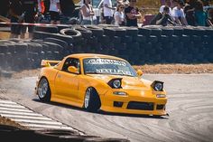 a yellow car driving down a race track