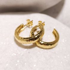 Eye catcher pair of thick chunky hand forged hoop earrings from solid 18k yellow gold. Using only traditional techniques each piece is unique, shaped , forged and hammered by hand, the result is an elegant and classy pair suitable for every occasion. Product details : * solid 18k gold * hand forged * Diameter 2,3 cm * Thickness 5,3 mm Custom orders Custom orders are always welcome! We are very flexible with custom orders and we can accommodate almost any request concerning metal, engravings, sto Yellow Gold Polished Hoop Earrings As Gift, Yellow Gold Hoop Earrings With Polished Finish As Gift, Hammered Gold Round Huggie Earrings, Hammered Yellow Gold Hoop Earrings, Gold Hammered Round Huggie Earrings, Handmade Yellow Gold Round Huggie Earrings, Classic Handmade Gold Huggie Earrings, Hammered Yellow Gold Hoop Huggie Earrings, Classic Handmade Gold Hoop Earrings