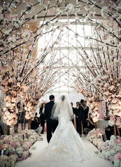 the bride and groom are walking down the aisle