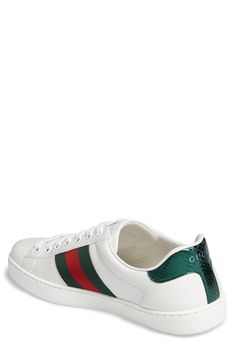 Signature web stripes and bold embroidery bring together two of Gucci's most distinctive house codes on this classic leather sneaker. Contrasting heel tabs are a modern reference to the brand's official colors. Style Name:Gucci New Ace Sneaker (Men). Style Number: 5415061. Sporty Gucci Sneakers With Embossed Logo, Gucci Sneakers With Embossed Logo And Round Toe, Casual Gucci Sneakers With Embossed Logo, Gucci Sneakers With Contrast Sole For Streetwear, Gucci Low-top Luxury Sneakers, Gucci Luxury Sneakers With Branded Insole, Gucci Luxury Sneakers With White Sole, Luxury Gucci Sneakers With White Sole, Designer Gucci Sneakers With Embossed Logo