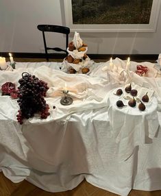 the table is covered with fruit and candles