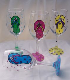 four wine glasses with different designs on them