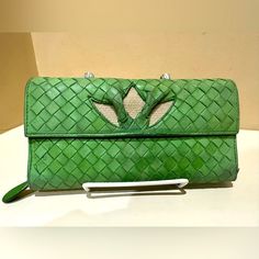 Bottega Veneta Intrecciato Long Bifold Wallet Soft Leather Green Flower Italy Good Used Condition Bottega Long Wallet. Gorgeous Wallet In A Bright, Grassy Green Color. The Cutout On The Front Is A Woven Canvas. Snap Closure Open Side With Divider And Space For Credit Cards And Money, Etc. Zip Around Compartment Expands And Has Two Sides With A Divider Lots Of Space To Keep Everything Organized Width: 7 3/8" Height: 4" Depth: 1" I Have Pictured The Serials And The Made In As Well. The Zipper Works Well And The Snap Holds Firmly. Thanks For Looking! Bottega Veneta Bags, Bottega Veneta Intrecciato, Green Cream, Green Flowers, Long Wallet, Bottega Veneta, Soft Leather, Colorful Flowers, Green Colors