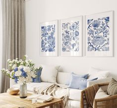 the living room is decorated with blue and white floral wall art, along with wicker furniture