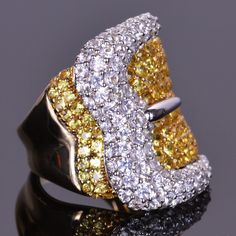 Fun, unique and elegant. This ring is masterfully made in 14k white and yellow gold, and is set with over 5.5 carats of vibrant white and yellow sapphires. Affordable Diamond Rings, 2 Carat Diamond Ring, Diamond Rings For Women, Vintage Diamond Jewelry, Beautiful Baubles, Love Knot Ring, Geek Jewelry, Buckle Ring, Beautiful Belts