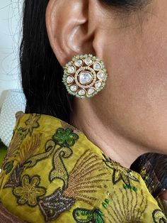 Restocked ♥️ On popular demand  This gorgeous Bridal Studs will add a perfect charm to your festive wear. One of our favorite picks for the wedding season  The diameter of the studs is 3cms. The weight of the studs is 12 grams per pair. Notice the zirconia stones bordering the center Kundan piece. Premium Quality Colour: Mint Green Kundan Jhumkas With Gota Work For Reception, Wedding Chandbali Jhumkas With Dori Work, Chandbali Jhumkas With Dori Work For Wedding, Zari Work Jhumkas For Diwali Reception, Zari Work Jhumkas For Reception And Diwali, Festive Bridal Earrings With Meenakari For Reception, Kundan Bridal Earrings With Zari Work For Reception, Green Chandbalis With Gota Work For Wedding, Bollywood Style Gota Work Earrings For Reception