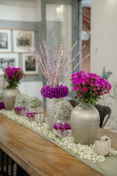 purple flowers are in vases on a table