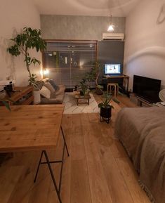 a living room filled with furniture and a flat screen tv sitting on top of a wooden table